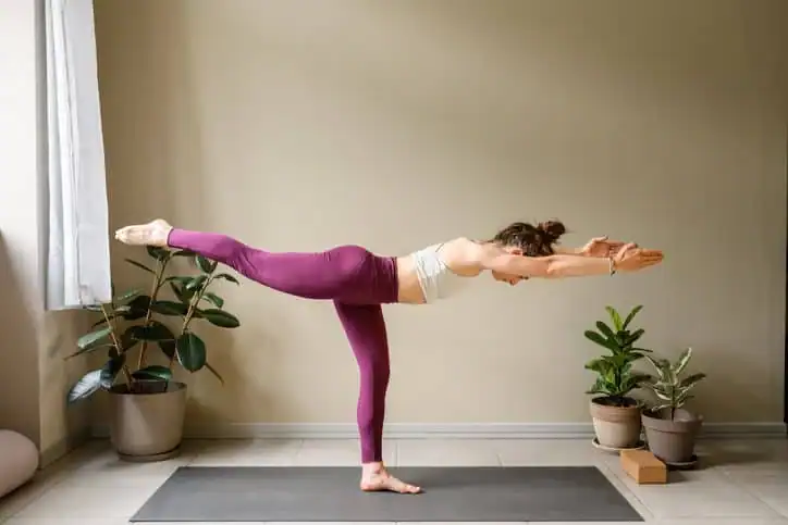 Woman doing Yoga exercise Brentford to help with toning the body. 